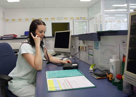 Medical administrator answering a phone call